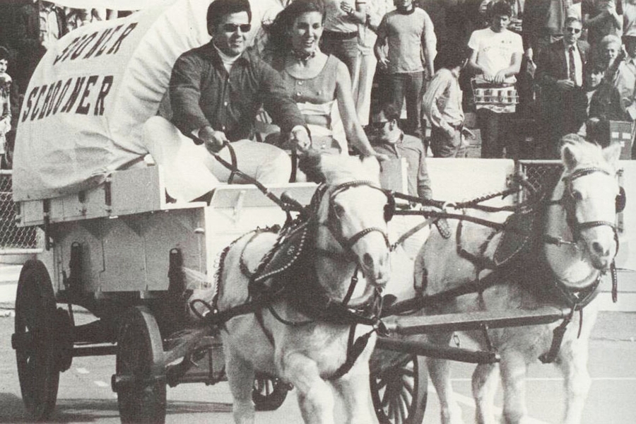 A black and white historical photo of the Sooner Schooner, pulled by two ponies.