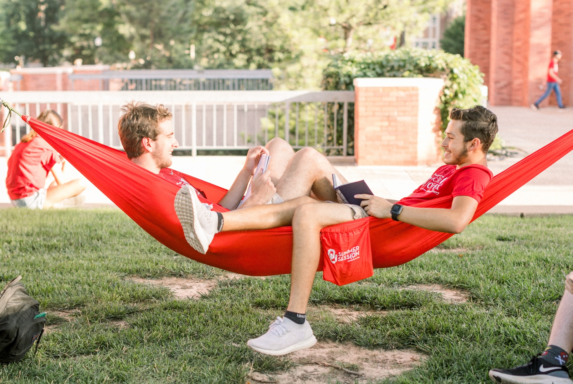 Two students relaxing in a hammock