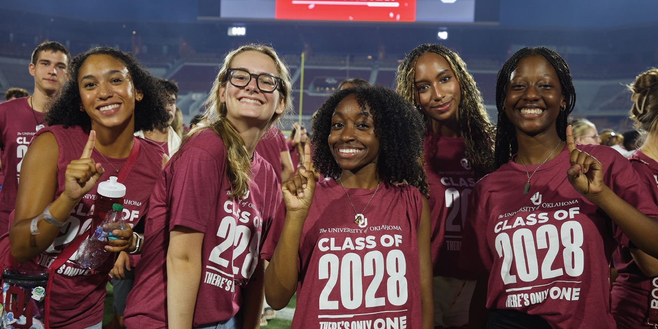 Students from the class of 2027 hold a crimson sign that says "Largest Class in OU's History" while celebrating Class Kickoff, held at the Gaylord Family - Oklahoma Memorial Stadium.