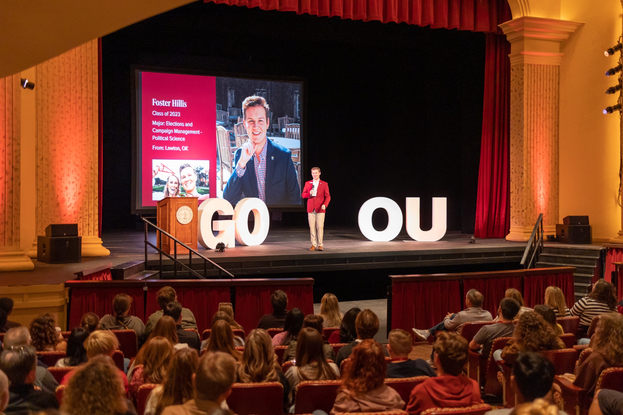 Student on stage speaking to prospective students