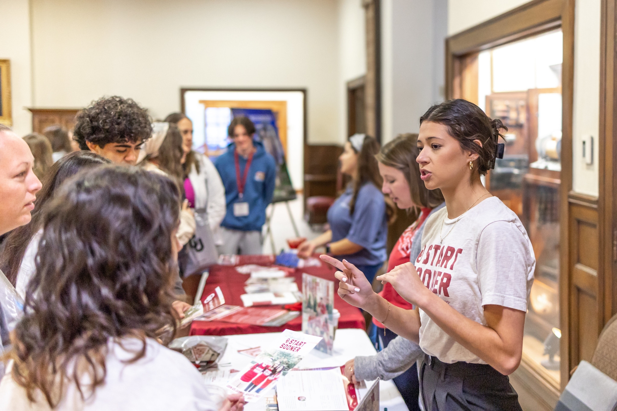 Prospective student talking to current student at booth