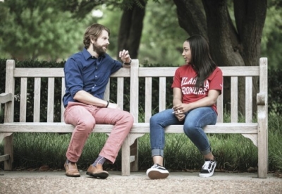 Coach and student talking on bench