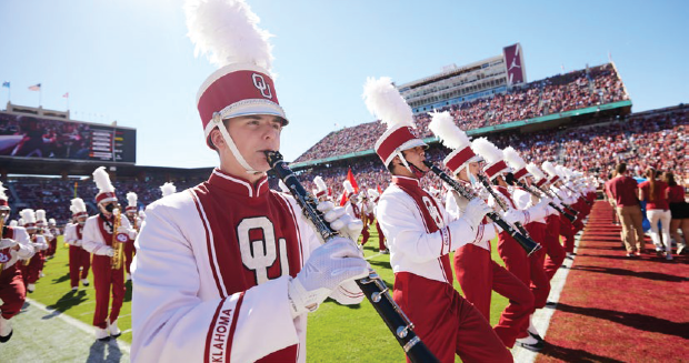 The Pride of Oklahoma marches on the field of Gaylord Family Oklahoma Memorial Stadium.