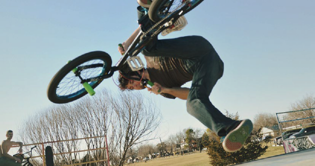 A person performs a jump trick on a bicycle.