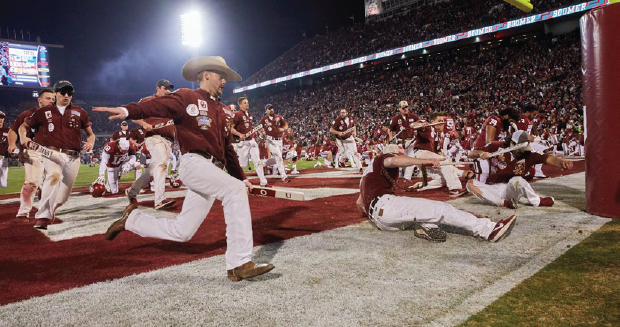 OU Rufnecks running in the end zone of the Gaylord Family Oklahoma Memorial Stadium field.