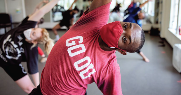 Students stretching in an OU dance studio.