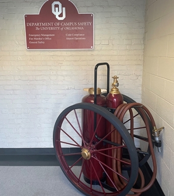 The Department of Campus Safety sign with fire hose located in the Department of Campus Safety office.