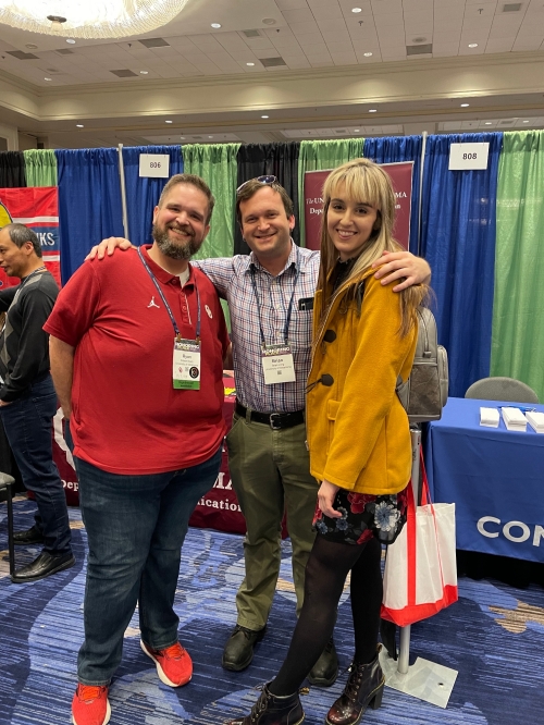 Three GTA's pose for a photo at a convention