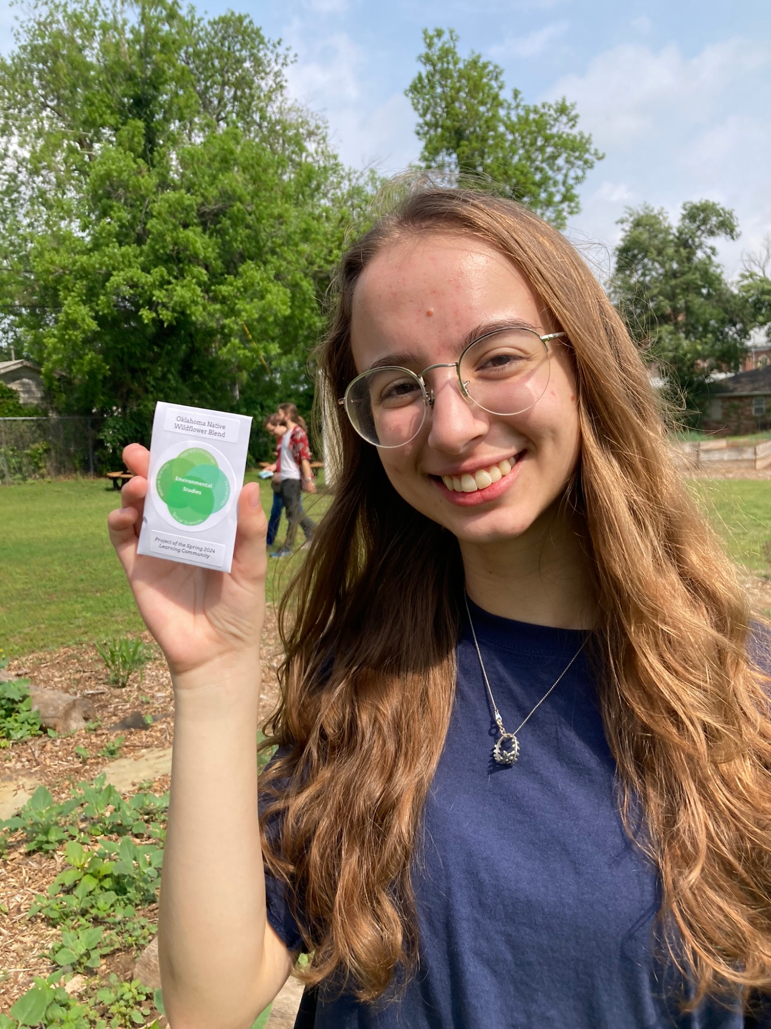 Madison holds up a seed packet.