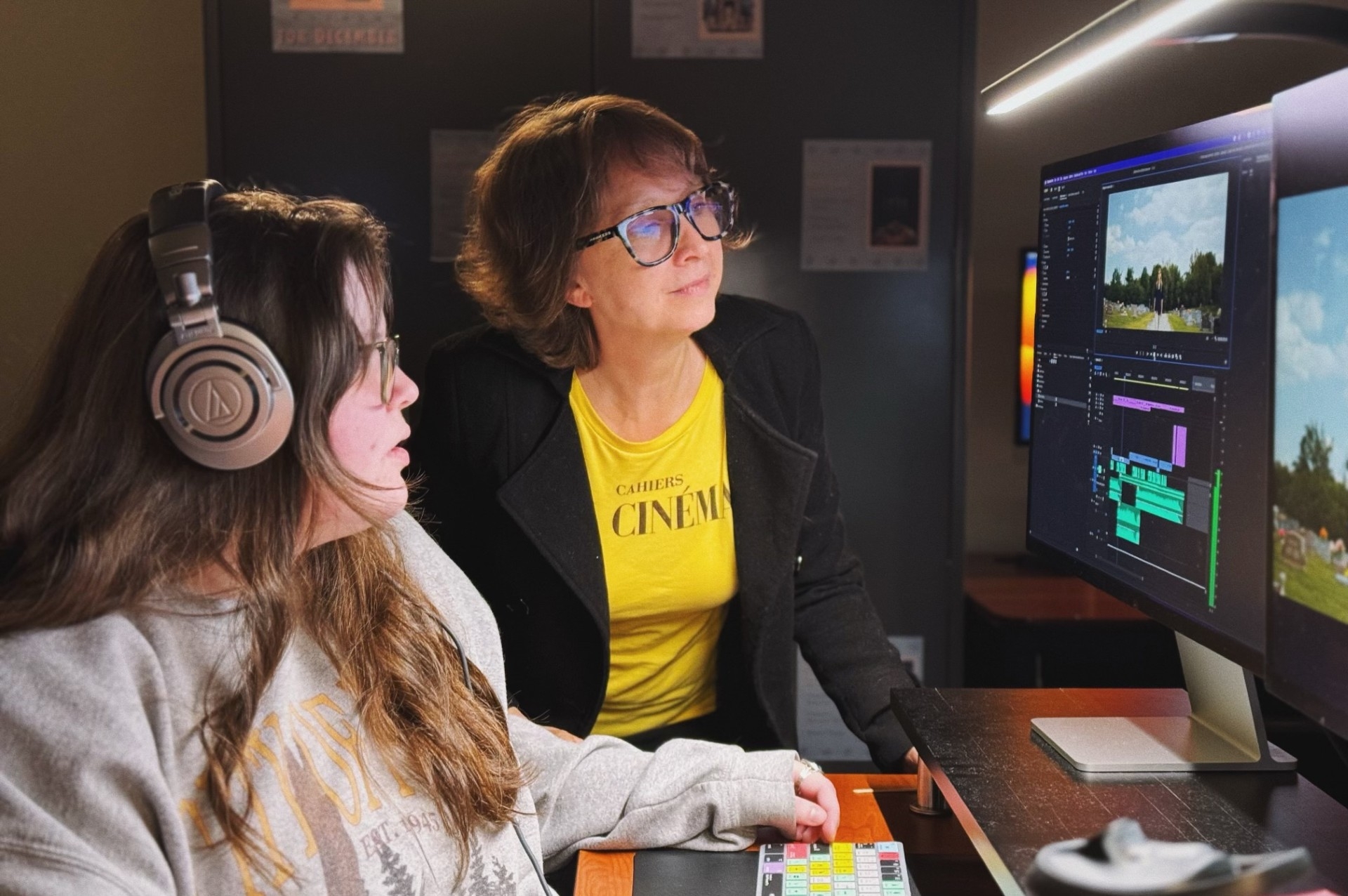 Photo of a professor helping a student edit her project.