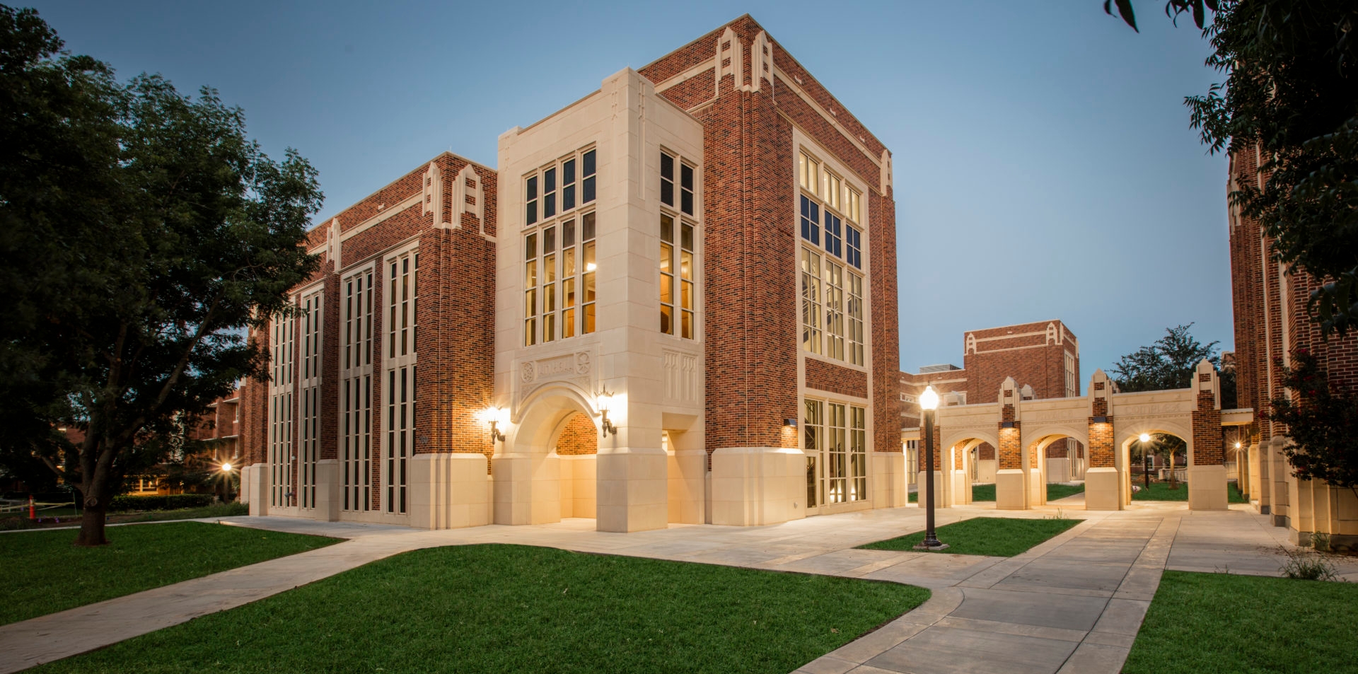 A photo of Lin Hall lit up in the early evening twilight.