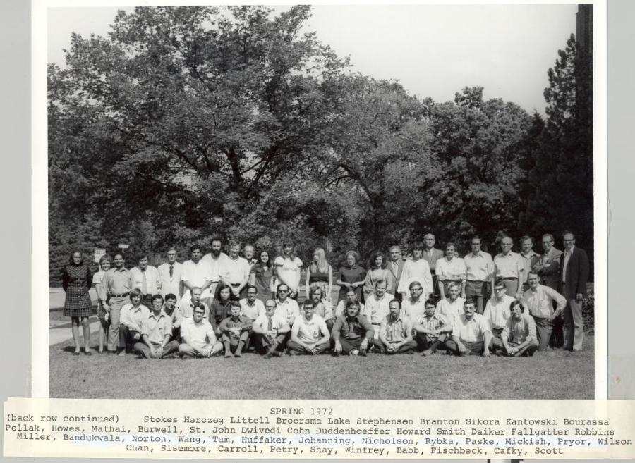 1971-1972 group photo in black and white. Text under photo: "Spring 1972 [First line] (back row continued) Stokes, Herczeg, Littell, Broersma, Lake, Stephensen, Branton, Sikora, Kantowski, Bourassa, [Second line] Pollak, Howes, Mathai, Burwell, St. John, Dwivedi, Cohn, Duddenhoeffer, Howard, Smith, Daiker, Fallgatter, Robbins, [Third line] Miller, Bandukwala, Norton, Wang, Tam, Huffaker, Johanning, Nicholson, Rybka, Paske, Mickish, Pryor, Wilson, [Fourth line] Chan, Sisemore, Carroll, Petry, Shay, Winfrey, Babb, Fischbeck, Cafky, Scott."