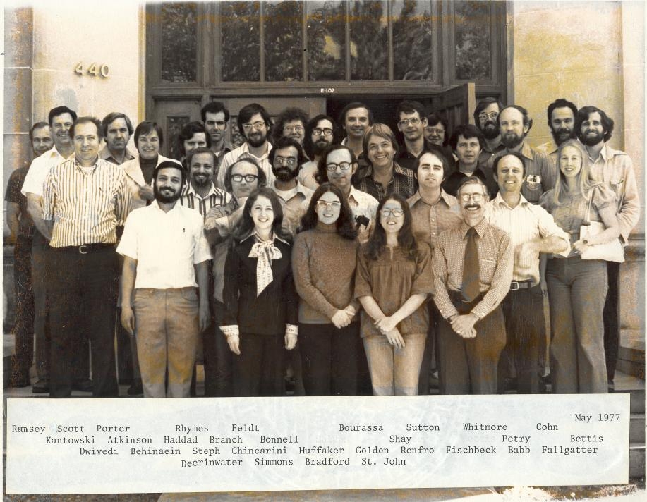 1976-1977 group photo in sepia. Text under photo: "[First line] May 1977, Ramsey, Scott, Porter, Rhymes, Feldt, Bourassa, Sutton, Whitmore, Cohn, [Second line] Kantowski, Atkinson, Haddad, Branch, Bonnell, Shay, Petry, Bettis, [Third line] Dwivedi, Behinaein, Steph, Chincarini, Huffaker, Golden, Renfro, Fischbeck, Babb, Fallgatter, [Fourth line] Deerinwater, Simmons, Bradford, St. John."