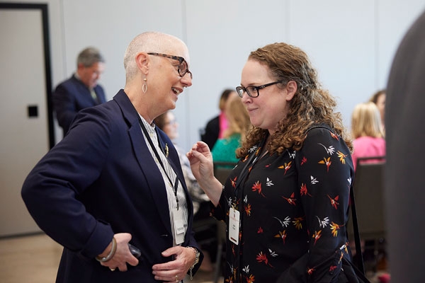 Professor Alisa Fryar to the left talking with Associate Dean Kyncl.