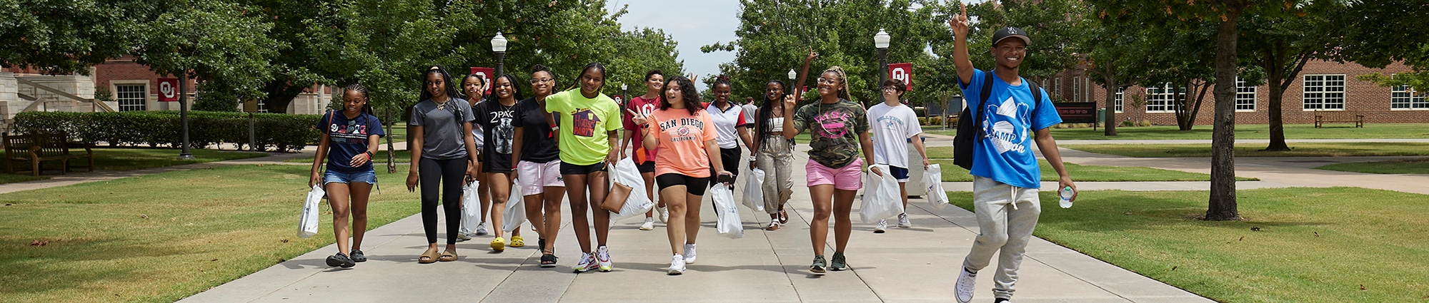 Students walking on campus sidewalk.