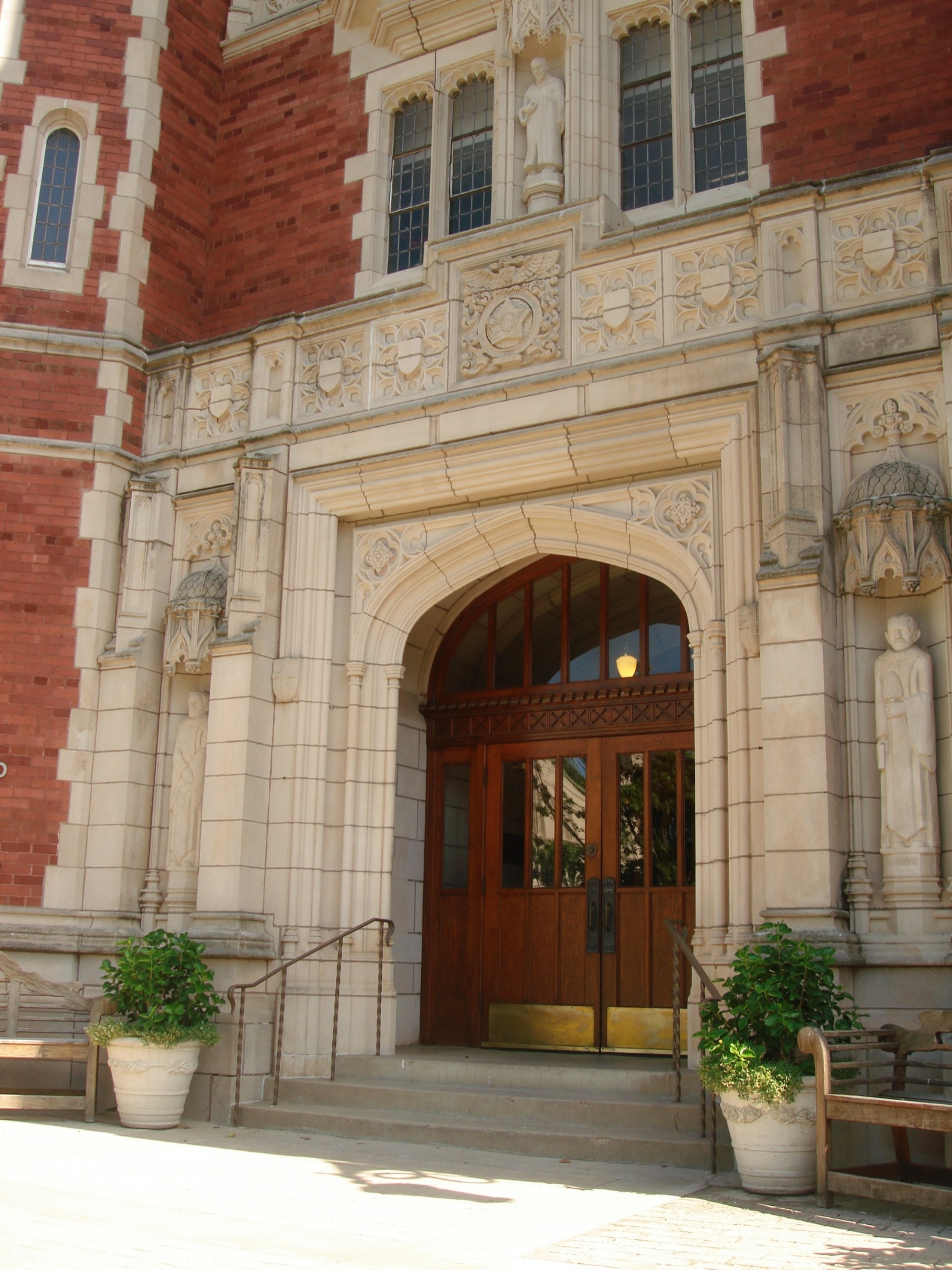 The exterior doors of Evans Hall with gothic stonework and heavy wooden doors.