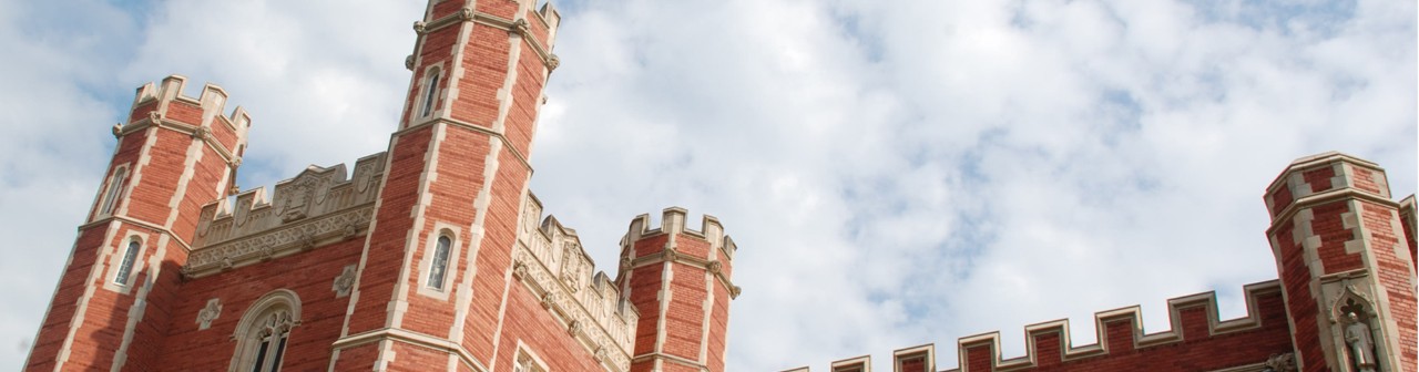 A view facing the top the historic south entrance of Bizzell Library with blue skies and clouds.