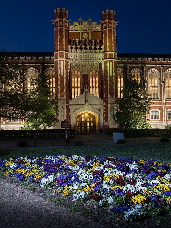 Bizzell Library at night with flowers