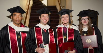 CIS graduate students posing at graduation.