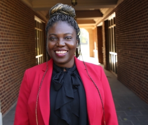 Nwannedinma Elizabeth Greb, in a red blazer, outside Farzaneh Hall