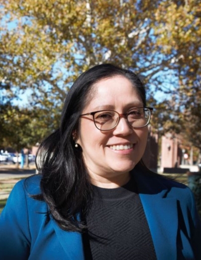 Karla Linares, blue blazer and dark shirt, on the South Oval