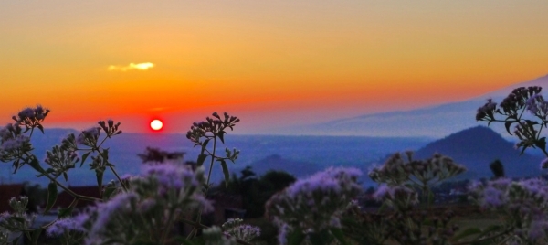 Scene of mountains, trees and sunset, courtesy of Peace Corps
