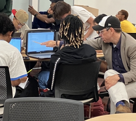 Student working with professor at study night