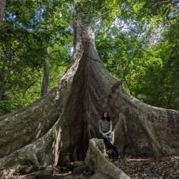 Olivia Mitchell standing by a large tree in Sri Lanka