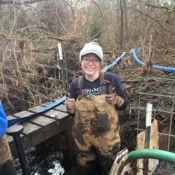 M'Kenzie Dorman stands in muddy waders
