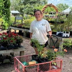 Jessica Burke with a cart of plants