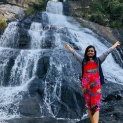 Nethmi Wickrama Gunarathne with a waterfall