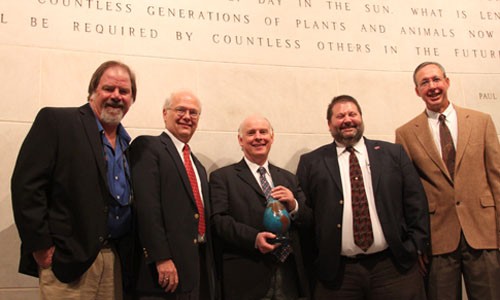 Ben Fawcett holds Water Prize standing with group of WaTER Center leaders.