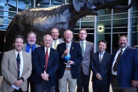 Peter Lochery holds Water Prize standing with group of WaTER Center leaders.