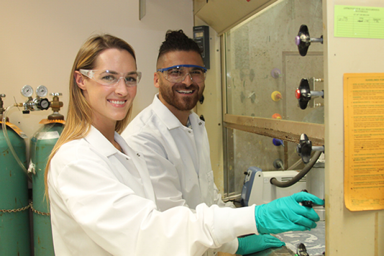 CBME Students Smiling at Vent Hood