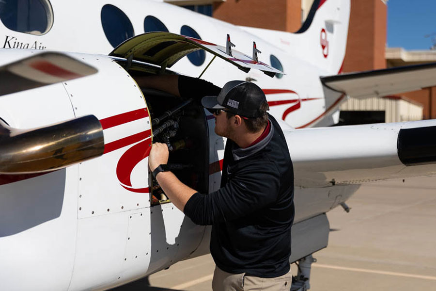 An OU student working on an OU airplane.