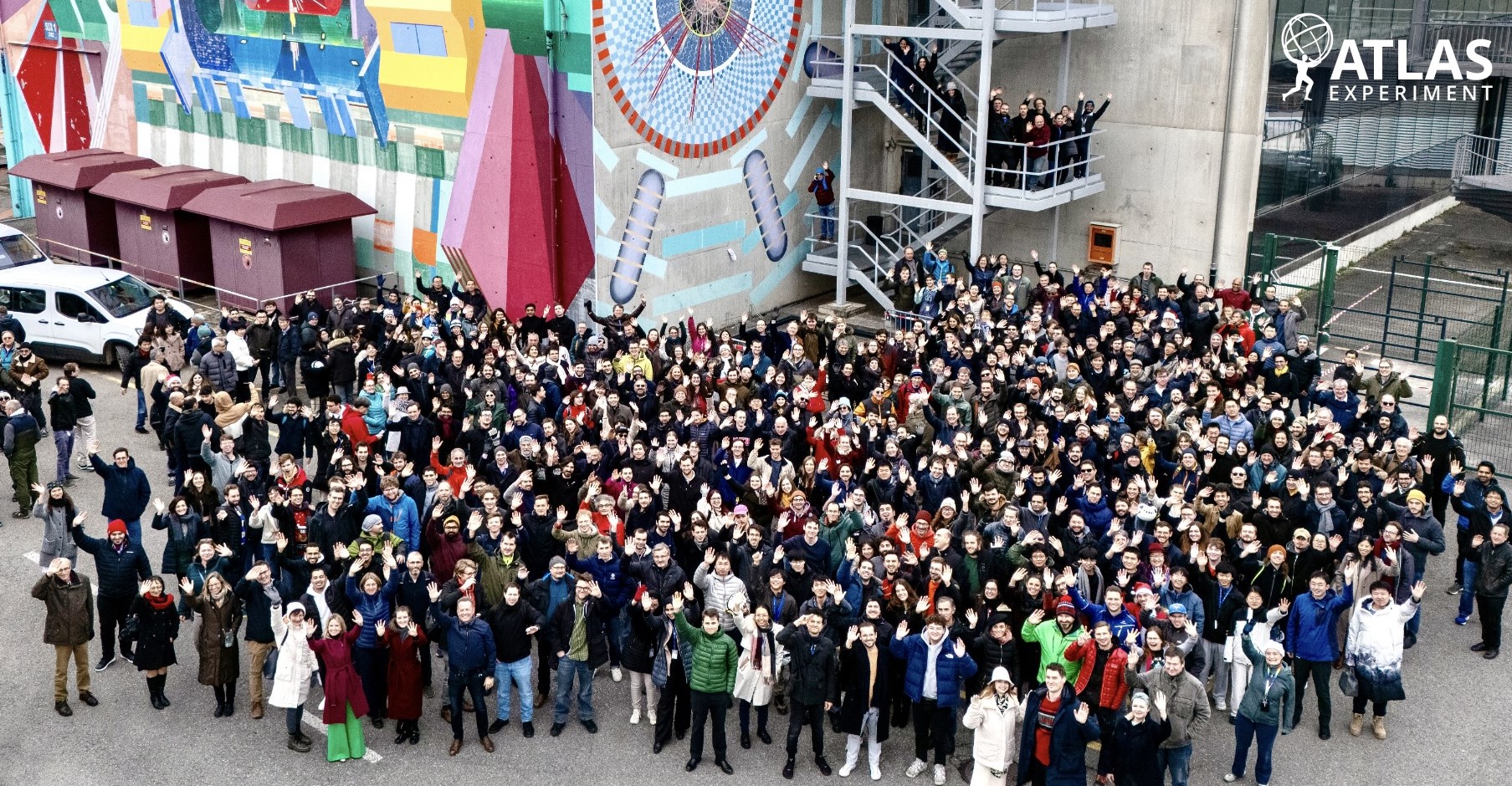 A group of people stand outside posing for a picture.
