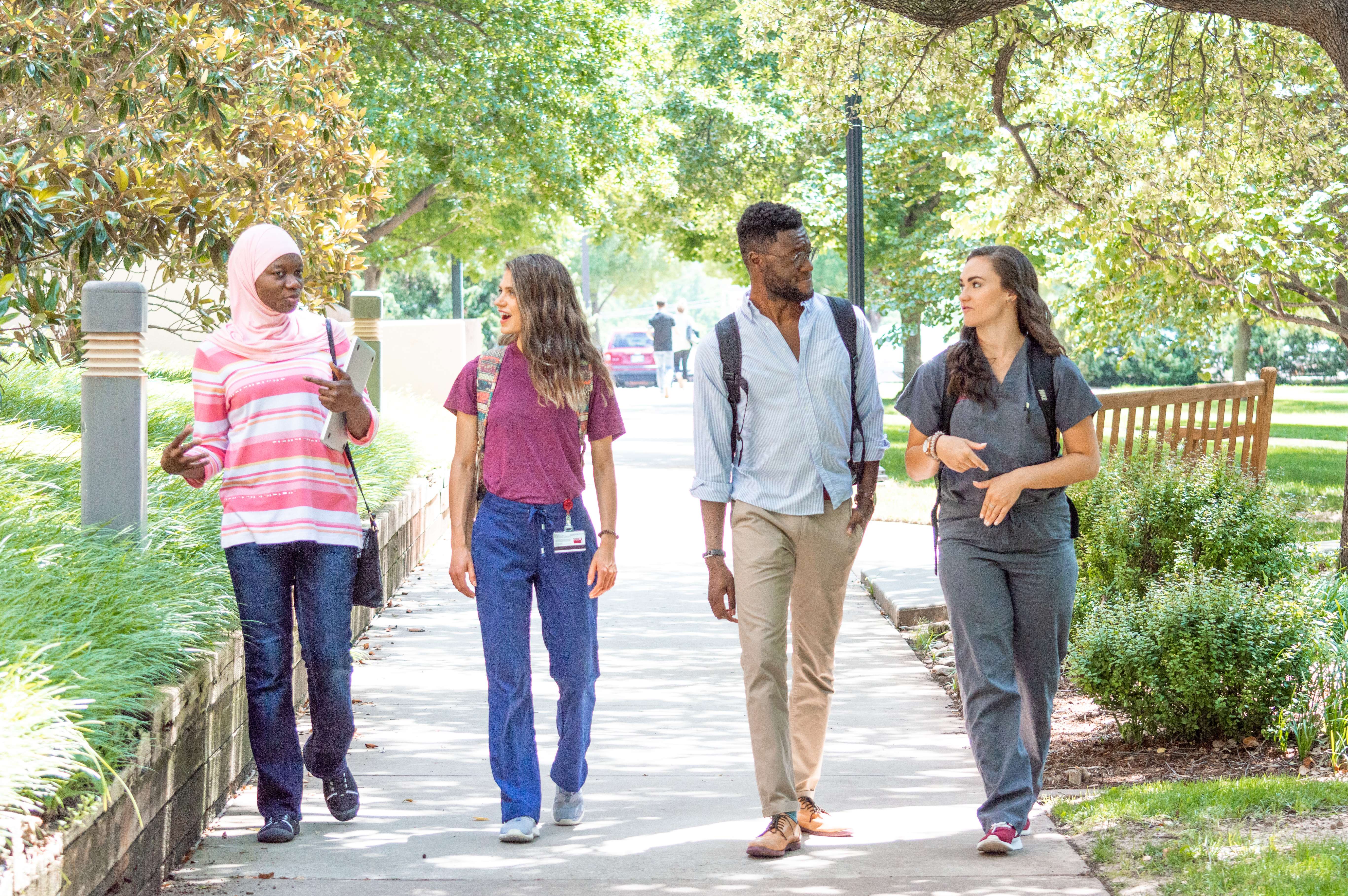 students walking down a sidewalk