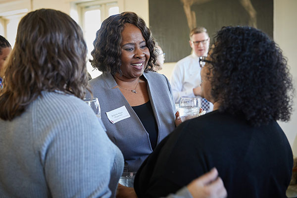 Dr. Belinda Hyppolite talking to people at event on OU campus.