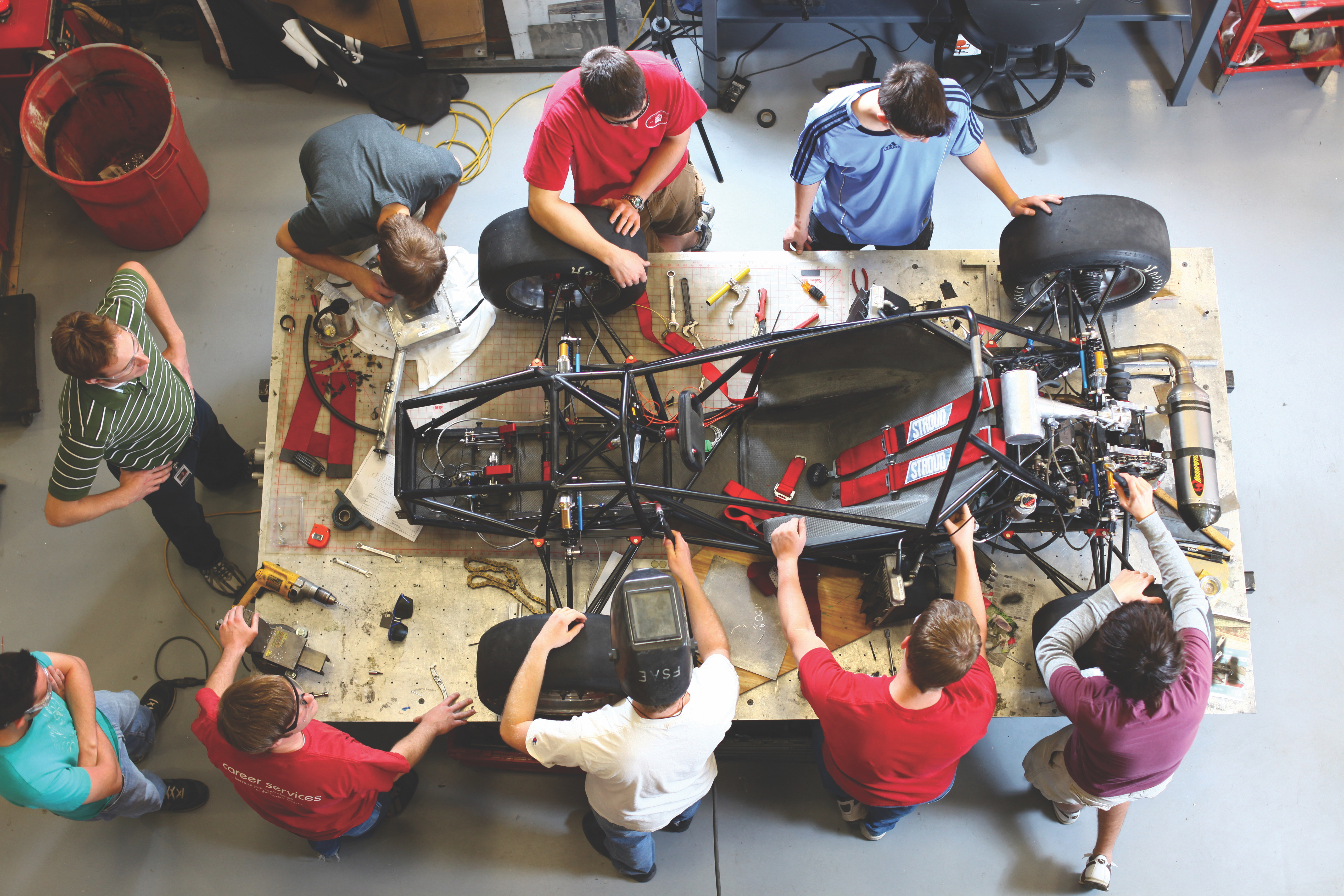 Engineering students working on a robotics vehicle. 