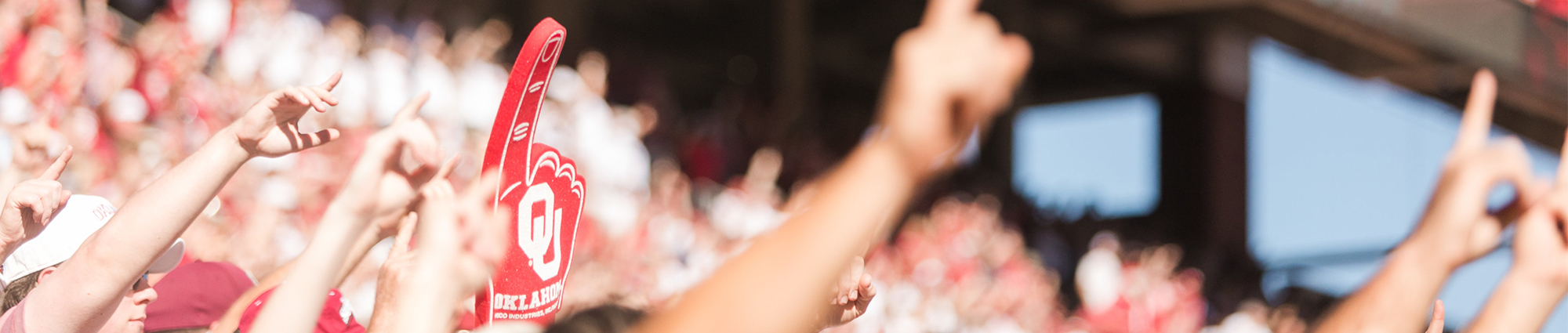 OU football game with hands raised