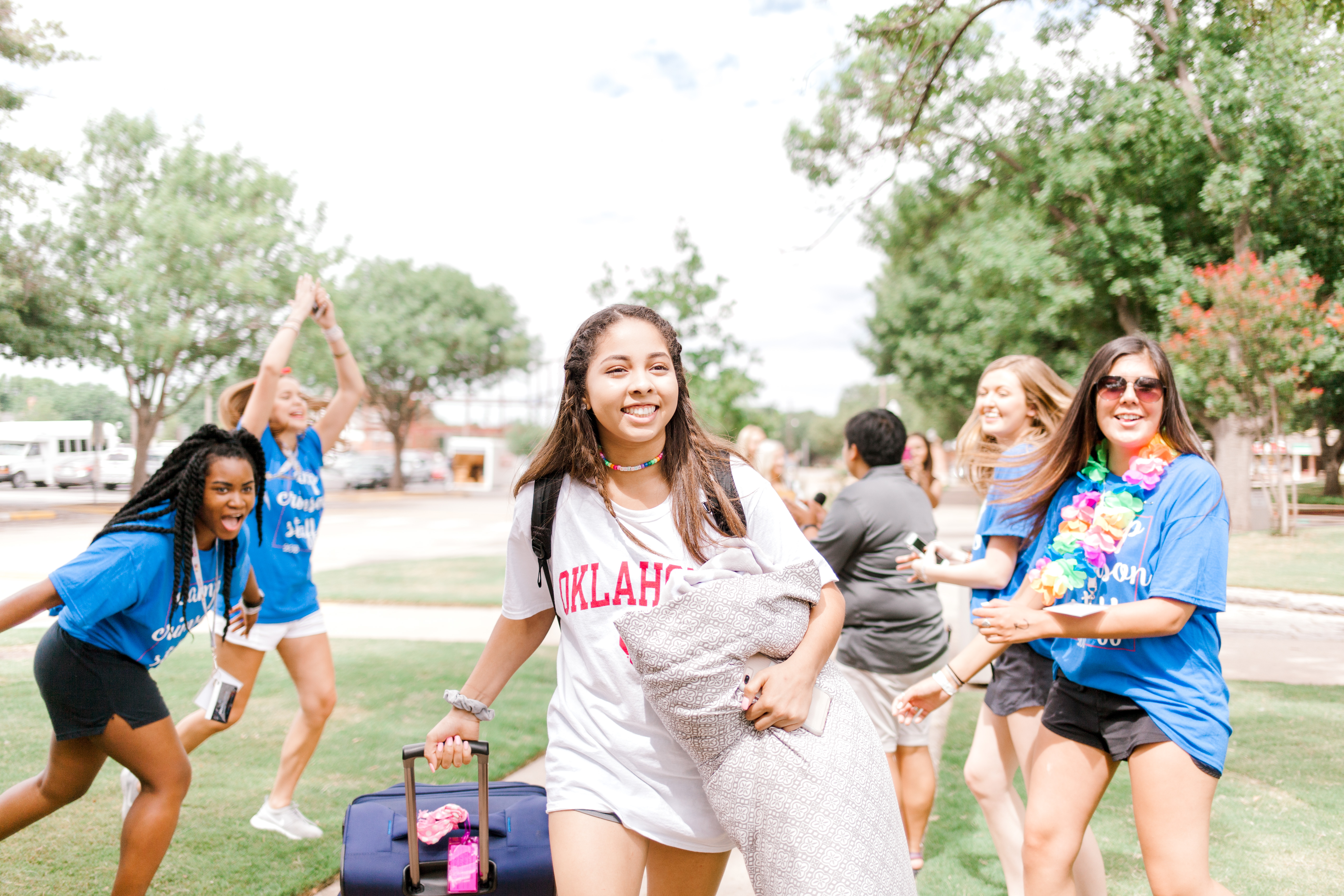 students welcoming new student to campus