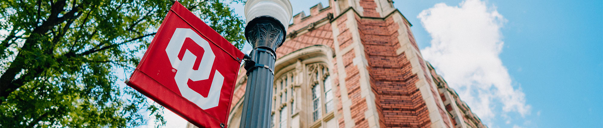 Ou flag in foreground and building in background
