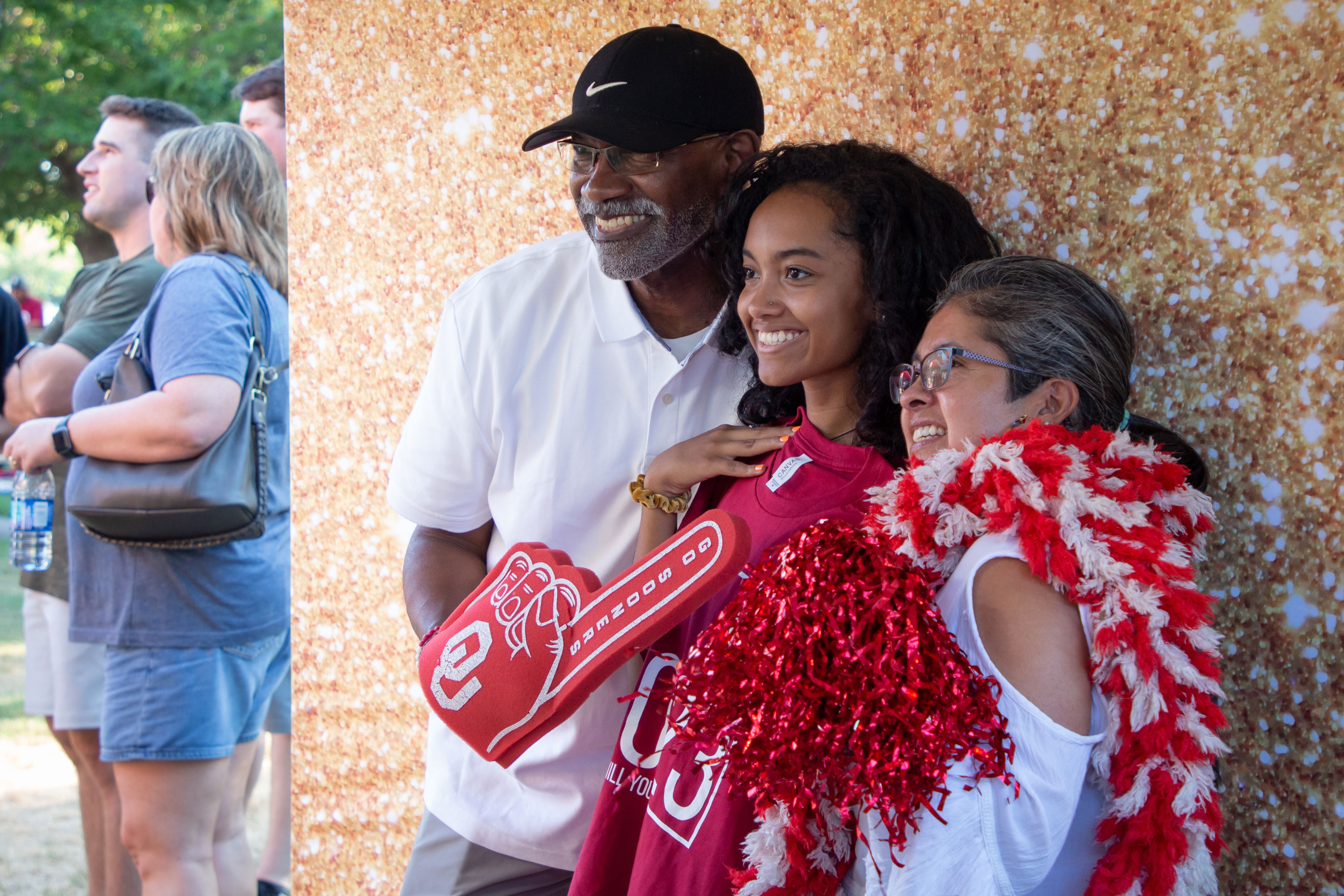 Student and family holding OU props