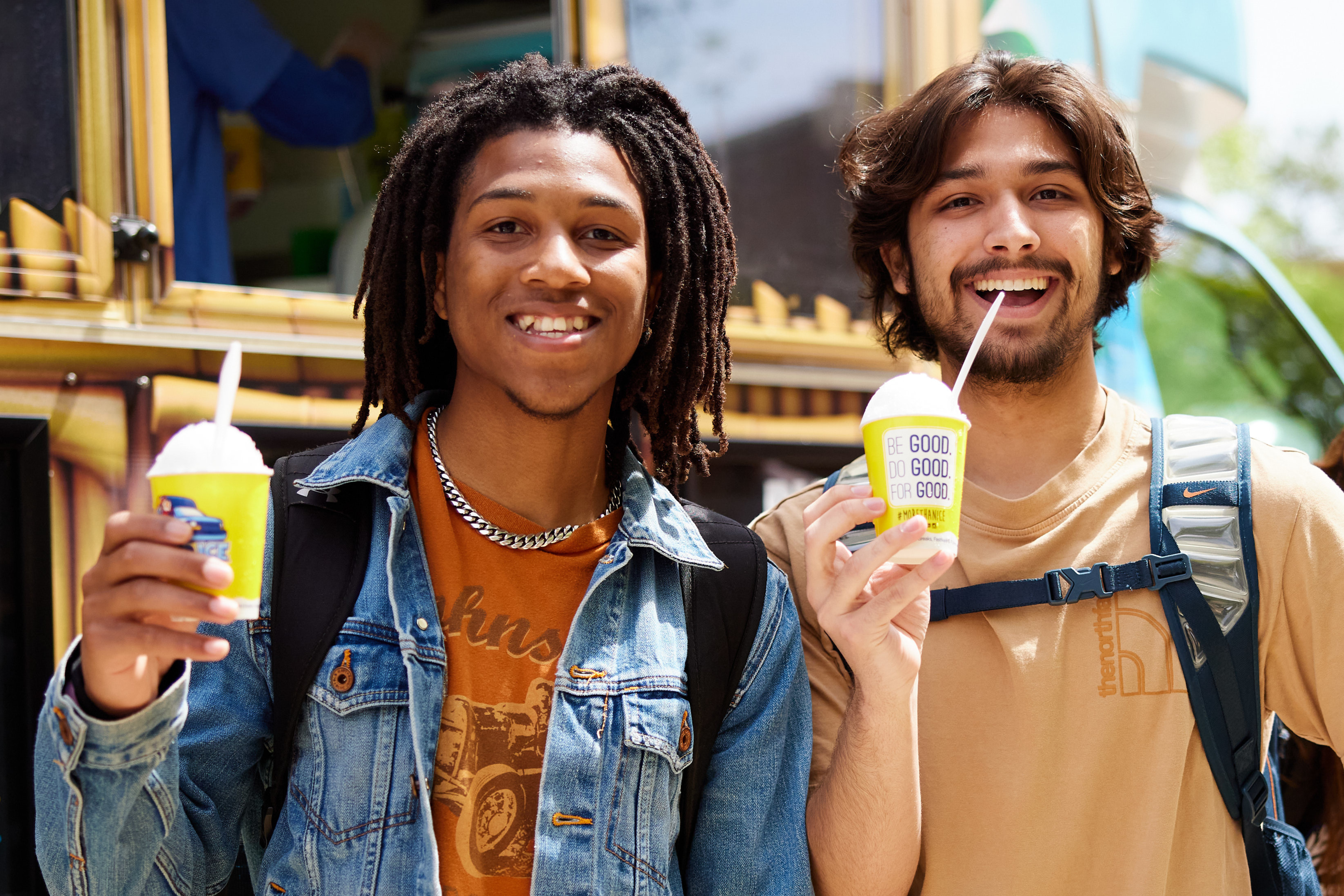 Students smiling and holding snow cones on the South Oval.