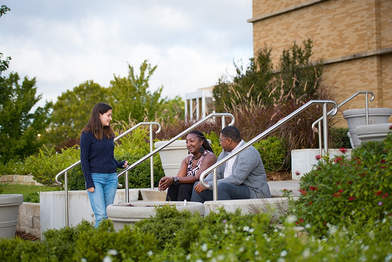 OU Tulsa students sitting on stairs on the campus