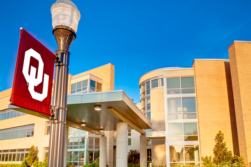 OU Tulsa building with an OU flag in the foreground