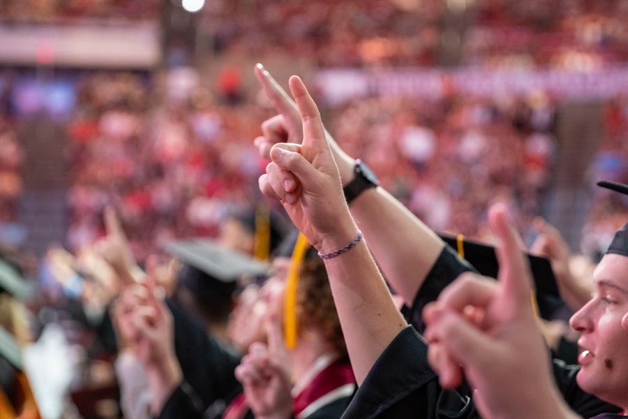 OU students at graduation singing their alma mater.