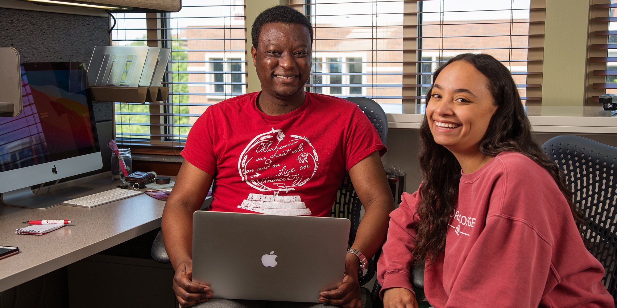 Students smiling in graduate suite