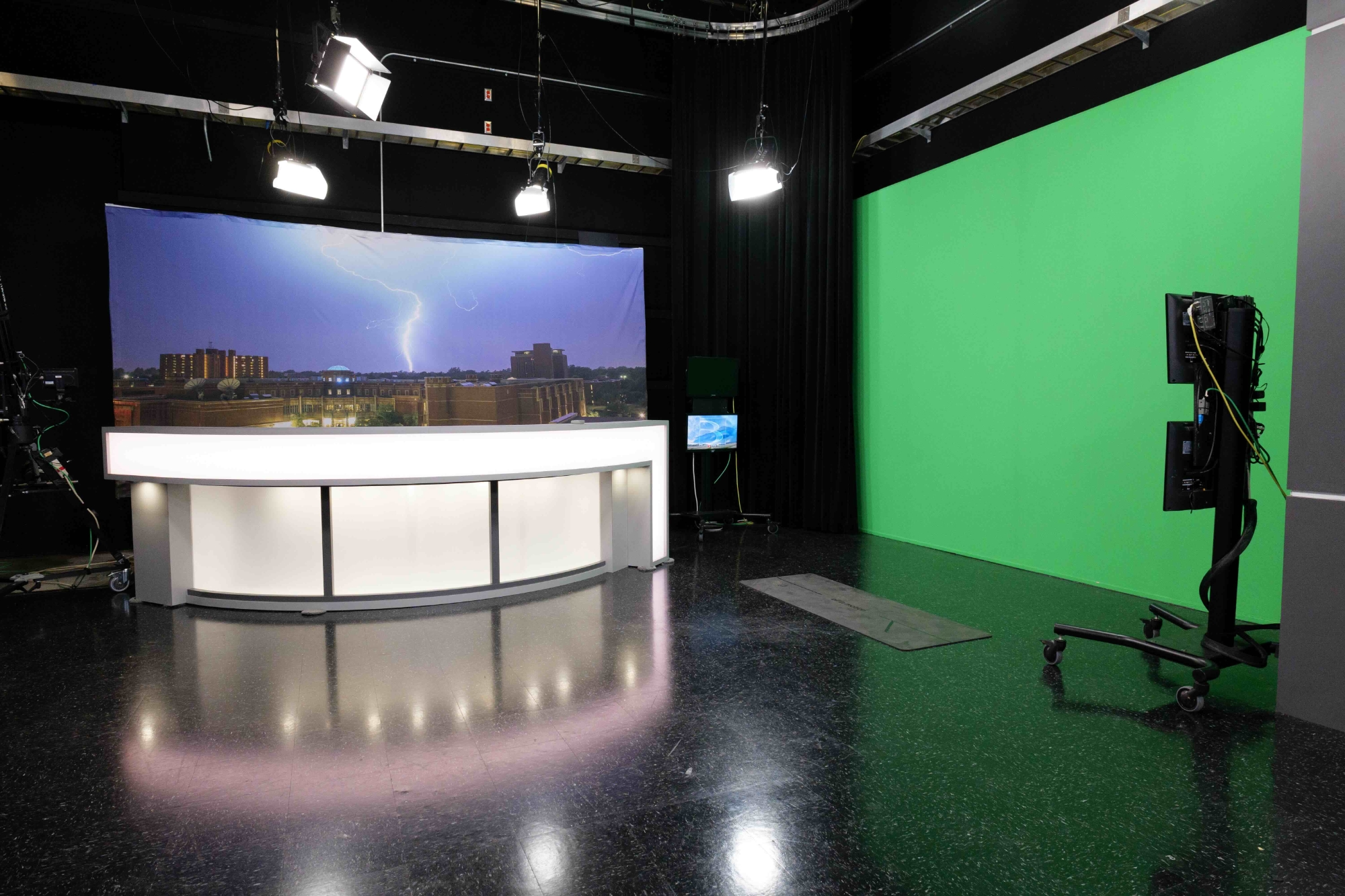 Behind the scenes of a broadcast lab with a camera and control board.