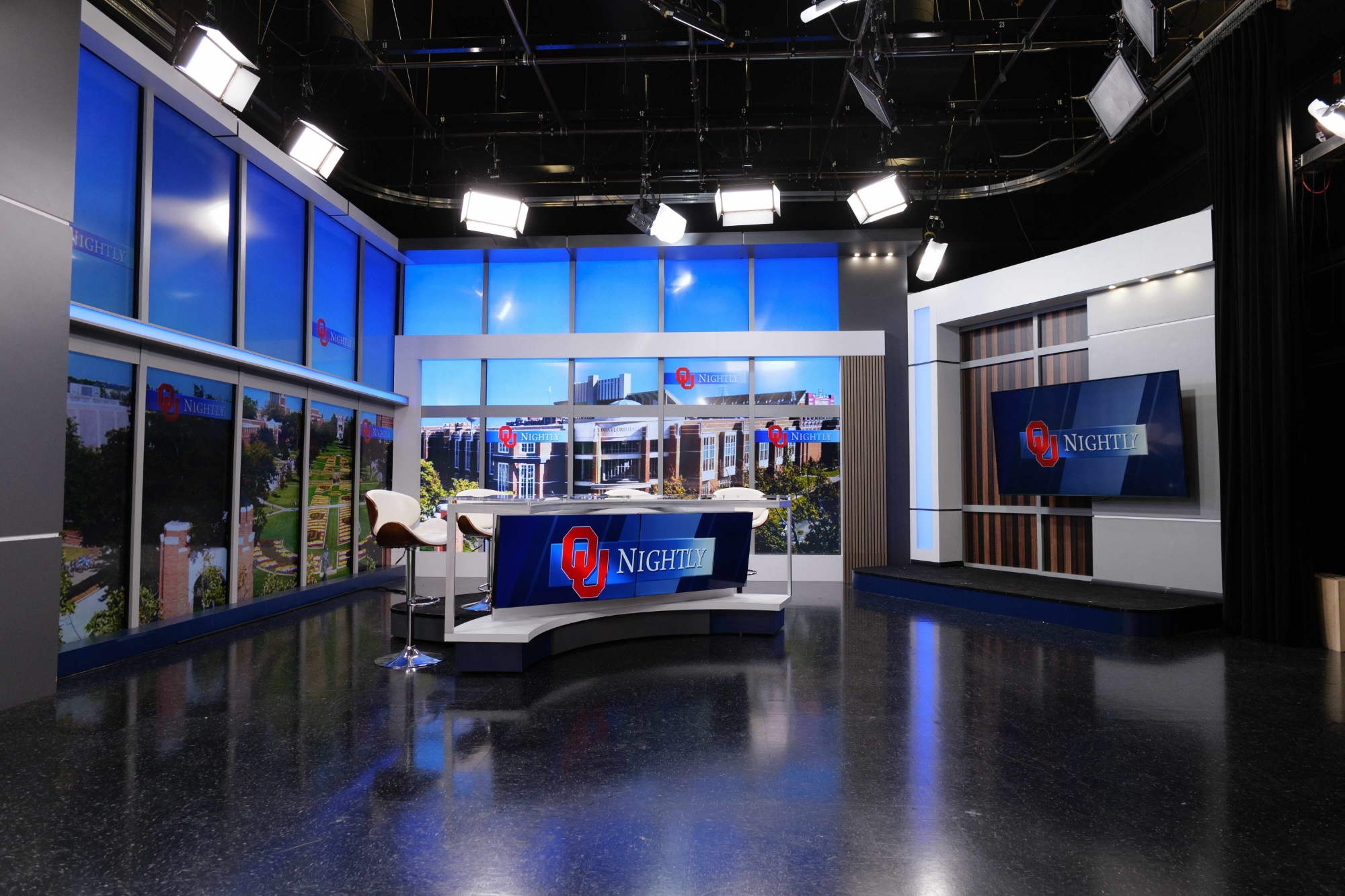 Behind the scenes of a broadcast lab with a camera and control board.
